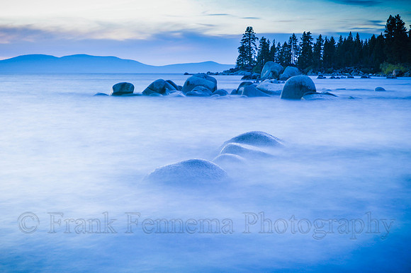 Zephyr Cove boulders appear floating in fog